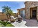 Cozy back patio featuring comfortable outdoor seating, a modern fire pit, and a decorative palm tree at 12353 W Running Deer Trl, Peoria, AZ 85383
