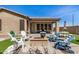 Well-maintained backyard with a covered patio, a firepit, and comfortable seating areas at 12353 W Running Deer Trl, Peoria, AZ 85383