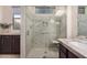 Spacious bathroom featuring a frameless glass shower with a built-in seat and a double sink vanity at 12353 W Running Deer Trl, Peoria, AZ 85383