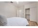 Neat bedroom with light hardwood floors and a double door closet for plentiful storage space at 12353 W Running Deer Trl, Peoria, AZ 85383