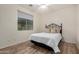 Bright bedroom with a comfortable bed, neutral-toned walls, and natural light from a window at 12353 W Running Deer Trl, Peoria, AZ 85383