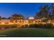 Inviting clubhouse exterior with manicured landscaping and warm lighting, perfect for relaxation and community gatherings at 12353 W Running Deer Trl, Peoria, AZ 85383