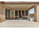 Inviting covered patio with lounge seating and a ceiling fan for outdoor relaxation at 12353 W Running Deer Trl, Peoria, AZ 85383