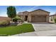 Inviting home featuring a well-manicured artificial lawn, mature trees, and a private courtyard entrance at 12353 W Running Deer Trl, Peoria, AZ 85383