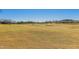 Expansive golf course with gentle slopes, sand traps, and clear blue sky at 12353 W Running Deer Trl, Peoria, AZ 85383