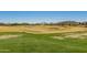 Scenic golf course with lush green grass and mature trees under a clear blue sky at 12353 W Running Deer Trl, Peoria, AZ 85383