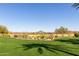 Expansive green lawn with manicured landscaping, offering views of the golf course and mountain scenery at 12353 W Running Deer Trl, Peoria, AZ 85383
