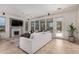 Bright living area highlighting a fireplace, large windows, a comfortable sofa, and tile flooring at 12353 W Running Deer Trl, Peoria, AZ 85383