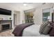 Cozy main bedroom with a fireplace, wood floors, and access to outdoor patio through sliding glass door at 12353 W Running Deer Trl, Peoria, AZ 85383