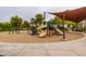 Community playground featuring slides, climbing structures, and a shaded area at 12353 W Running Deer Trl, Peoria, AZ 85383