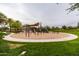 Community playground featuring swings, climbing structures, and a shaded area at 12353 W Running Deer Trl, Peoria, AZ 85383