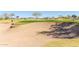 Expansive sand trap bordering a lush green golf course, offering a challenging yet scenic play environment at 12353 W Running Deer Trl, Peoria, AZ 85383