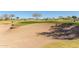 Expansive sand trap bordering a lush green golf course, offering a challenging yet scenic play environment at 12353 W Running Deer Trl, Peoria, AZ 85383