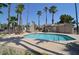 Sparkling community pool surrounded by palm trees, lounge chairs, and a picnic area at 14636 N Yerba Buena Way # B, Fountain Hills, AZ 85268