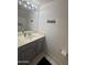 Well-lit bathroom featuring a modern vanity with a sleek countertop and ample storage at 1505 N Center St # 220, Mesa, AZ 85201