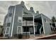 Stylish condo exterior showcasing architectural design, balconies, and stairs to the upper levels at 1505 N Center St # 220, Mesa, AZ 85201
