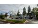 Charming apartment complex exterior featuring covered parking, mature trees, and lush green landscaping at 1505 N Center St # 220, Mesa, AZ 85201