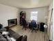 Spacious living room designed as an office featuring laminate floors, natural light, and modern fixtures at 1505 N Center St # 220, Mesa, AZ 85201