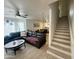 Open-concept living area showcasing the stairs, dining area, and comfortable seating arrangement at 1505 N Center St # 220, Mesa, AZ 85201