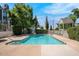 Community pool surrounded by mature trees and greenery, designed for relaxation and recreation at 1505 N Center St # 220, Mesa, AZ 85201
