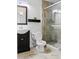 Bathroom featuring a framed mirror above vanity, a toilet, and a glass-enclosed shower with tile surround at 15243 N 52Nd Dr, Glendale, AZ 85306