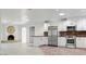 Open-concept kitchen with stainless steel appliances and modern white cabinets at 15243 N 52Nd Dr, Glendale, AZ 85306