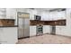 Updated kitchen with stainless steel appliances, granite countertops, and ample white cabinetry at 15243 N 52Nd Dr, Glendale, AZ 85306