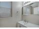 Bathroom vanity features a clean design with modern sink, mirror and lighting fixtures at 15346 W Hearn Rd, Surprise, AZ 85379