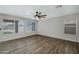 Bright bedroom with wood floors, a ceiling fan, and large windows providing ample natural light at 15346 W Hearn Rd, Surprise, AZ 85379