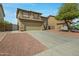 Two-story home with a tile roof, two car garage and low maintenance landscaping at 15346 W Hearn Rd, Surprise, AZ 85379