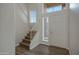 Bright foyer with staircase, window, and a view of the entry door at 15346 W Hearn Rd, Surprise, AZ 85379