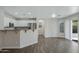 Bright kitchen features stainless appliances, granite countertops, and counter seating area at 15346 W Hearn Rd, Surprise, AZ 85379