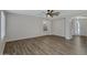 Open living room with wood floors, neutral walls, and a ceiling fan at 15346 W Hearn Rd, Surprise, AZ 85379