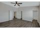Spacious main bedroom featuring wood floors, ensuite bath and ceiling fan at 15346 W Hearn Rd, Surprise, AZ 85379