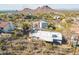 Aerial view showcasing home's gray exterior, desert surroundings, and mountain views at 1637 E Camino Del Santo --, Phoenix, AZ 85022