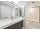 Elegant bathroom featuring modern vanity, stylish mirrors, and tiled shower and flooring at 1637 E Camino Del Santo --, Phoenix, AZ 85022