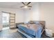 Cozy bedroom features a sliding barn door to bathroom and modern ceiling fan at 1637 E Camino Del Santo --, Phoenix, AZ 85022