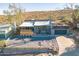 Stylish home featuring desert landscaping, a gray exterior, and a rooftop deck above the garage, offering outdoor living at 1637 E Camino Del Santo --, Phoenix, AZ 85022
