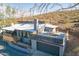 Stylish home featuring desert landscaping, a gray exterior, and a rooftop deck above the garage, providing outdoor living at 1637 E Camino Del Santo --, Phoenix, AZ 85022