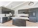 Stylish kitchen with dark cabinets, a white marble island, white countertops, stainless steel appliances, and light wood floors at 1637 E Camino Del Santo --, Phoenix, AZ 85022
