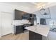Modern kitchen with dark cabinets, white countertops, stainless appliances, light wood floors, and a white door at 1637 E Camino Del Santo --, Phoenix, AZ 85022