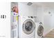 Efficient laundry room features side by side machines, hot water heater, and overhead storage at 1637 E Camino Del Santo --, Phoenix, AZ 85022