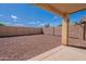 Spacious backyard area with gravel landscaping and a covered patio, perfect for outdoor living and entertaining at 168 S 223Rd Dr, Buckeye, AZ 85326