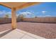 Spacious backyard area with gravel landscaping and a covered patio, perfect for outdoor living and entertaining at 168 S 223Rd Dr, Buckeye, AZ 85326