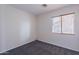 Empty bedroom with a window and carpeted floor at 168 S 223Rd Dr, Buckeye, AZ 85326