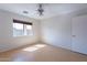 Empty bedroom with laminate flooring, a window and a closet at 168 S 223Rd Dr, Buckeye, AZ 85326
