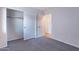 Bedroom with carpet flooring, a closet and access to an adjacent room at 168 S 223Rd Dr, Buckeye, AZ 85326