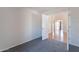 Bedroom with neutral carpet and an open door that leads to the living area, offering seamless flow and ample space at 168 S 223Rd Dr, Buckeye, AZ 85326