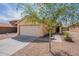 Single-story home with a well-kept front yard, featuring desert landscaping and a driveway leading to a two-car garage at 168 S 223Rd Dr, Buckeye, AZ 85326