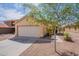 Inviting home exterior with desert landscaping, a two-car garage, and a walkway to the front door at 168 S 223Rd Dr, Buckeye, AZ 85326